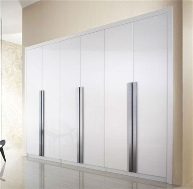 Thin narrow white freestanding wardrobe and wood cabinet with shelves